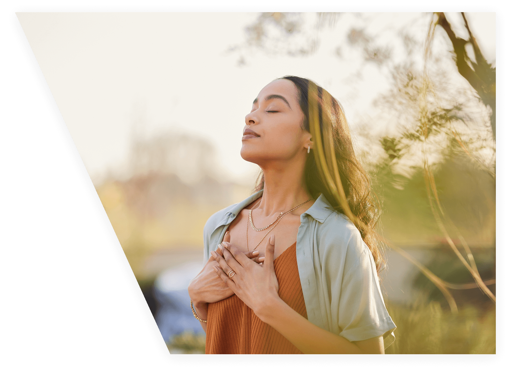 Woman meditating outdoors with eyes closed.